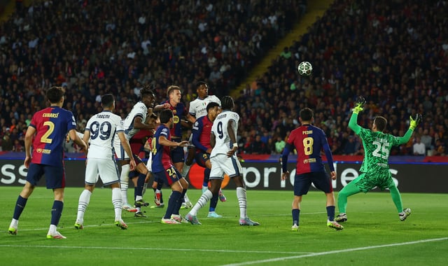 Soccer Football - Champions League - Semi Final - First Leg - FC Barcelona v Inter Milan - Estadi Olimpic Lluis Companys, Barcelona, Spain - April 30, 2025 Inter Milan's Denzel Dumfries scores their third goal past FC Barcelona's Wojciech Szczesny REUTERS/Albert Gea