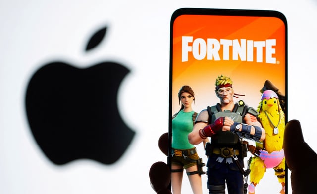 Fortnite game graphic is displayed on a smartphone in front of Apple logo in this illustration created on May 2, 2021. REUTERS/Dado Ruvic/Illustration