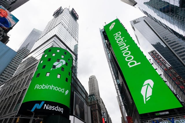 FILE – Electronic screens in New York’s Times Square announce the Robinhood IPO, July 29, 2021. (AP Photo/Mark Lennihan, File)