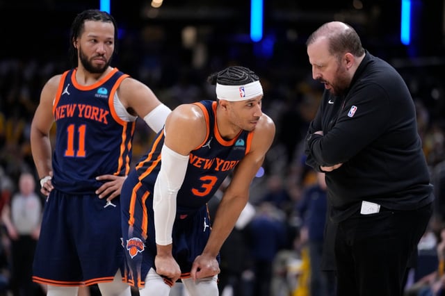 New York Knicks guard Jalen Brunson (11) and guard Josh Hart (3) talk with head coach Tom Thibodeau, right, during the second half of Game 4 against the Indiana Pacers in an NBA basketball second-round playoff series, Sunday, May 12, 2024, in Indianapolis. (AP Photo/Michael Conroy)