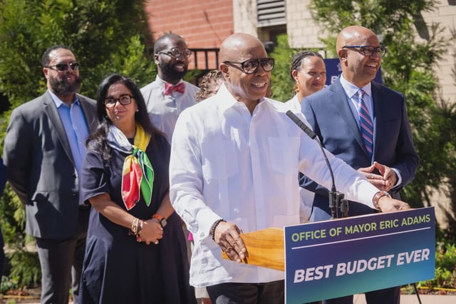 Adams has been promoting the budget while he runs for reelection.