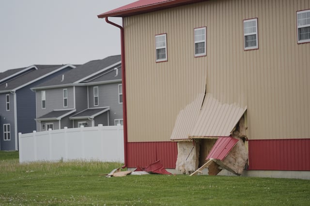 Damage is visible at the scene after a car barreled through a building used for an after-school camp Tuesday, April 29, 2025, in Chatham, Ill. (AP Photo/Erin Hooley)