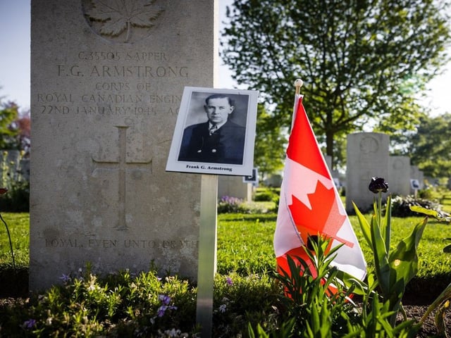  This photograph shows a picture of a fallen soldier at a grave during preparations for a memorial ceremony at the Groesbeek Canadian War Cemetery in Groesbeek, The Netherlands on May 1 2025, to commemorate 80th anniversary of the liberation of the Netherlands. Photo by ROB ENGELAAR / ANP / AFP) / Netherlands OUT