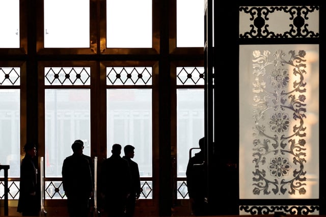 Security personnel keep watch at the second plenary session of the National People's Congress (NPC), at the Great Hall of the People in Beijing, China March 8, 2025. REUTERS/Tingshu Wang/File Photo