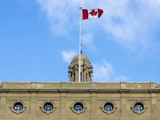 The Canadian flag flutters in the wind above the Alberta Legislature building on Tuesday, Nov. 5, 2024 in Edmonton.