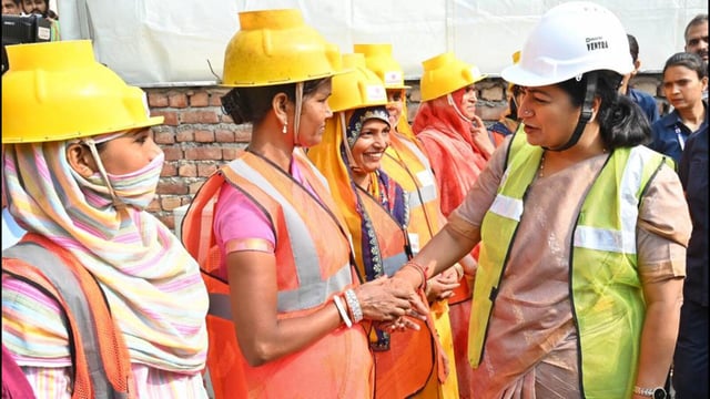Chief minister Rekha Gupta meets workers at a construction site at New Rohtak Road on World Labour Day in New Delhi on Thursday. (Vipin Kumar/HT Photo)