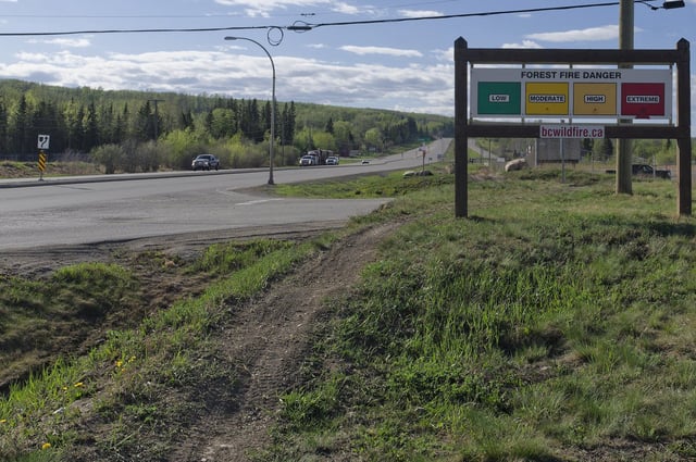 An extreme fire warning sign is shown along Highway 97 toward Fort Nelson outside the Charlie Lake Fire Hall near Fort St. John, B.C., on Monday, May 13, 2024. The B.C. Forest Ministry warns of elevated wildfire risk as winds arrive with warm, dry conditions. THE CANADIAN PRESS/Jesse Boily