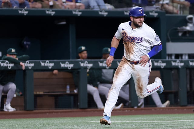 FILE PHOTOApr 29, 2025; Arlington, Texas, USA; Texas Rangers first base Jake Burger (21) scores a run during the third inning against the Oakland Athletics at Globe Life Field. Mandatory Credit: Tim Heitman-Imagn Images/File Photo