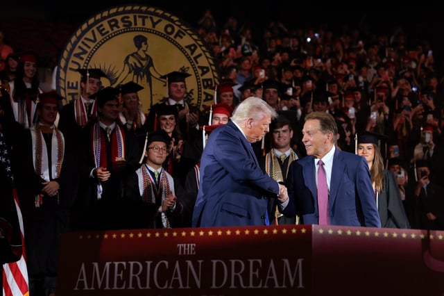 President Donald Trump shakes hands with former Alabama Crimson Tide football coach Nick Saban as Trump takes the stage to address graduating students at Coleman Coliseum at the University of Alabama on May 01, 2025 in Tuscaloosa, Alabama. Trumps remarks come the day before the University of AlabamaÕs official commencement ceremonies are set to begin.
