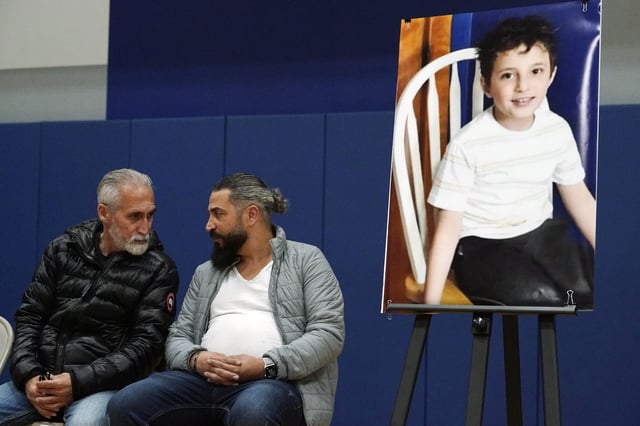 FILE - Wadee Alfayoumi's father, Oday Al Fayoume, seated right, and his uncle Mahmoud Yousef attend a vigil for Wadee at Prairie Activity and Recreation center in Plainfield, Ill., Oct. 17, 2023. (AP Photo/Nam Y. Huh, File)