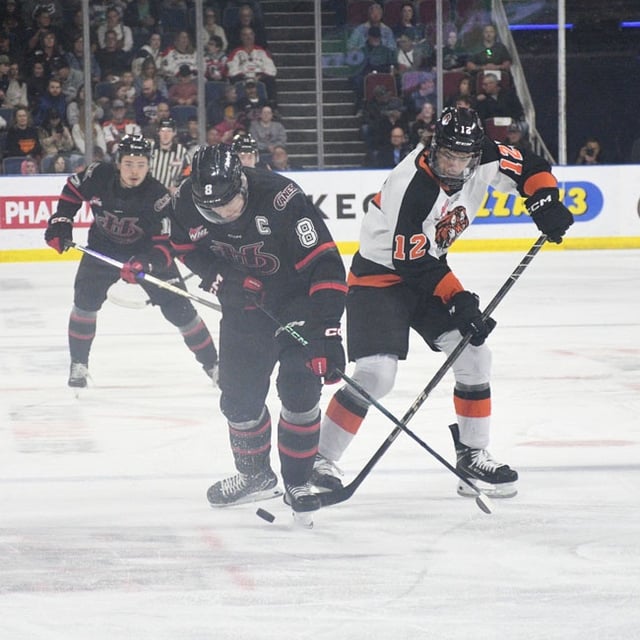 Herald Photo by Justin Seward Lethbridge Hurricanes Noah Chadwick attempts to keep the puck away from Liam Ruck of the Medicine Hat Tigers during Game 4 of the WHL's Eastern Conference final on Wednesday.