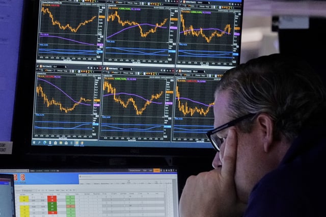 Specialist Gregg Maloney works at his post on the floor of the New York Stock Exchange, Monday, April 28, 2025. (AP Photo/Richard Drew)