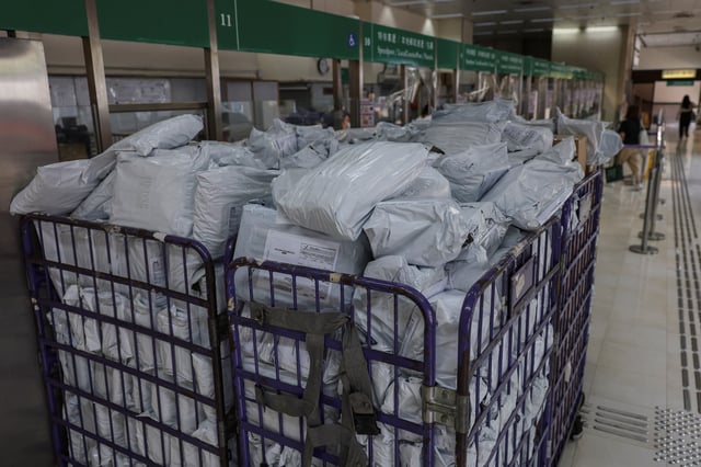 Parcels await processing at a post office as Hong Kong Post stops certain U.S.-bound shipments since April 27 due to new U.S. tariff rules, in Hong Kong, China, May 2, 2025. REUTERS/Tyrone Siu/File Photo