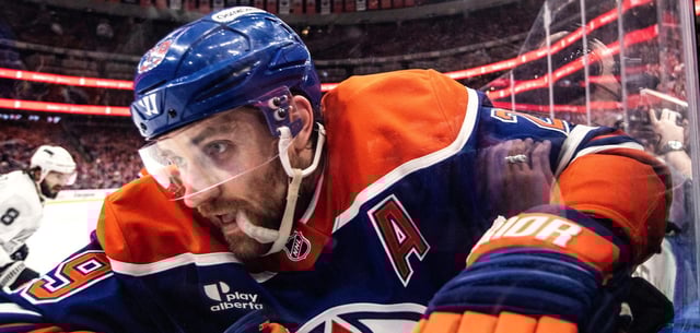 Leon Draisaitl im Zweikampf an der Bande