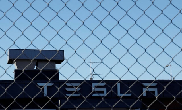A Tesla sign is displayed over a Tesla showroom in Malmo, Sweden, December 14, 2023. REUTERS/ Tom Little/File Photo
