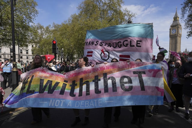 Campaigners take part in a rally organised by trans rights groups, trade unions, and community organisations following the Supreme Court ruling on the definition of a woman in equalities law, at Parliament Square, central London, Saturday April 19, 2025. (AP Photo/Alastair Grant)