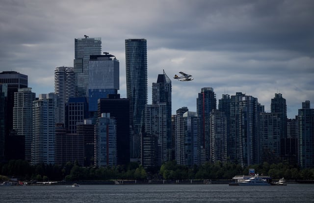 Vancouver home sales activity was down again in April as the city's real estate board says that with an ongoing trade war between Canada and the U.S., some buyers are likely trying to "patiently wait out the storm." A seaplane takes off past office and condo towers as a boat refuels at a floating Chevron station on the water, in Vancouver, on Thursday, July 25, 2024. THE CANADIAN PRESS/Darryl Dyck