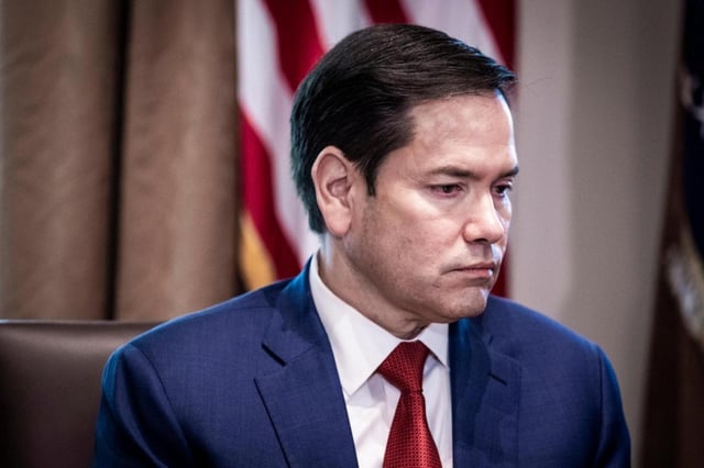 Secretary of State Marco Rubio looks on as President Donald Trump meets with his Cabinet in the West Wing of the White House in Washington, April 30, 2025. The former senator from Florida, now the head of four government agencies, has outdone Henry Kissinger and even Xi Jinping, China’s leader, who has only three titles. (Pete Marovich/The New York Times)