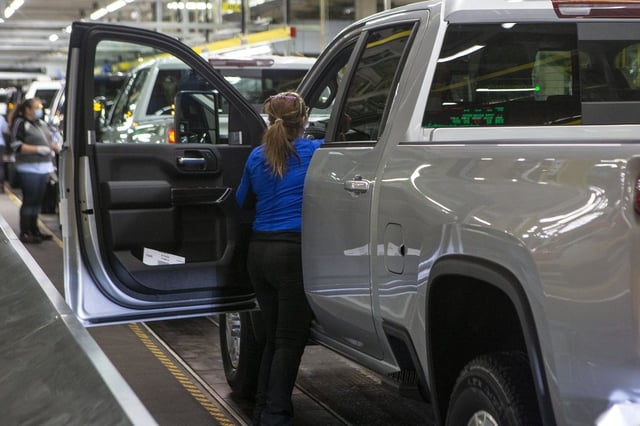 An autoworker is seen on the General Assembly line  producing the Chevrolet Silverado, at the GM plant  in Oshawa, Ontario, on Tuesday, February 22 2022. THE CANADIAN PRESS/Chris Young