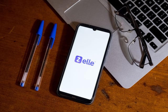 The Zelle logo is displayed on a smartphone in February 2024.