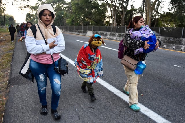 FILE - Women and children migrants walk with a larger group of migrants through Tapachula, Chiapas state, Mexico, in an attempt to reach the U.S. border, Jan. 20, 2025, the inauguration day of U.S. President Donald Trump. (AP Photo/Edgar H. Clemente, FIle)