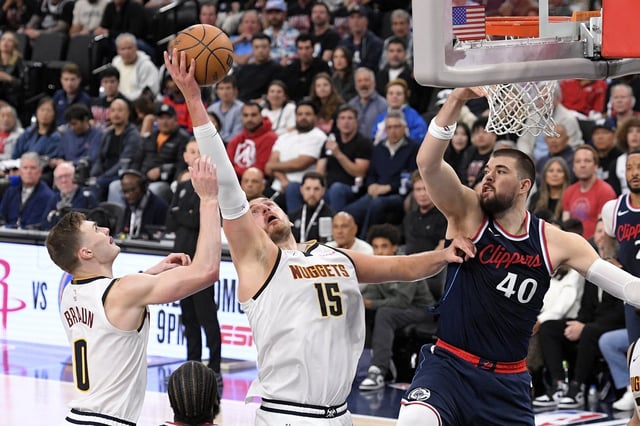 Denver Nuggets center Nikola Jokic, center, grabs a rebound away from Los Angeles Clippers center Ivica Zubac, right, as guard Christian Braun reaches during the second half in Game 6 of an NBA basketball first-round playoff series Thursday, May 1, 2025, in Inglewood, Calif. (AP Photo/Mark J. Terrill)