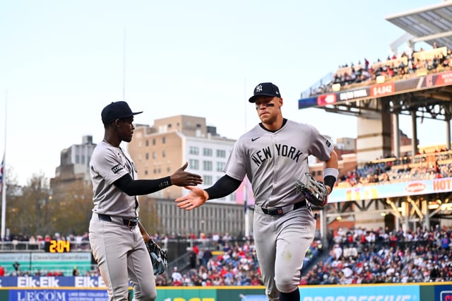 Jazz Chisholm Jr. #13 celebrates with Aaron Judge #99 of the New York Yankees after the fifth inning against the Cleveland Guardians at Progressive Field on April 22, 2025 in Cleveland, Ohio.