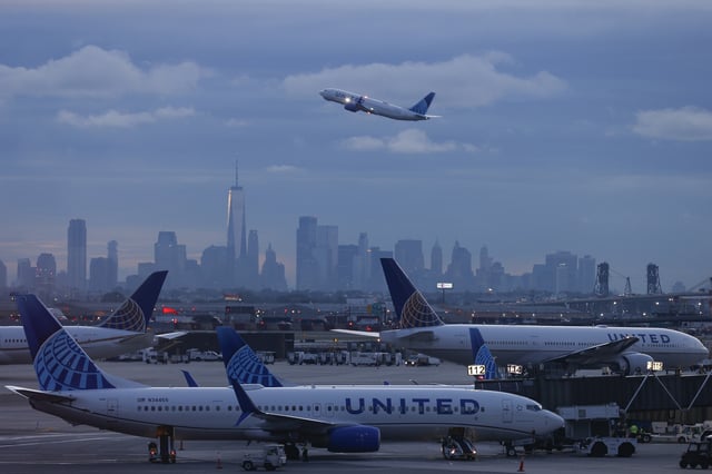 The lower Manhattan skyline, One World Trade Center and the city are seen in the background in front of United Airlines jets during sunrise at Newark Liberty International Airport (EWR), Friday, Sept. 20, 2024, in Newark, N.J.
