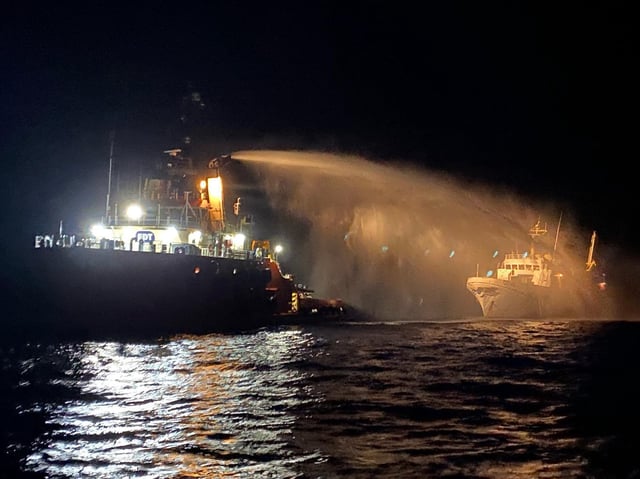 A photo handout from the Government of Malta shows a tug vessel putting out a fire onboard The Conscience, a ship with humanitarian aid bound for Gaza.