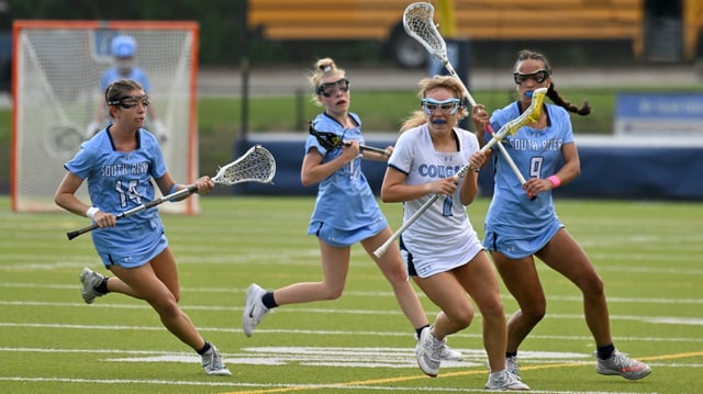 The South River defense of Annabella Burke, left, Sydney Starkey, center and Kelly Webber, right, seals off the advance of Chesapeake’s Mariah Danzer in the first quarter. The visiting South River Seahawks played the Chesapeake Cougars in girls high school lacrosse. (Paul W. Gillespie/Staff)
