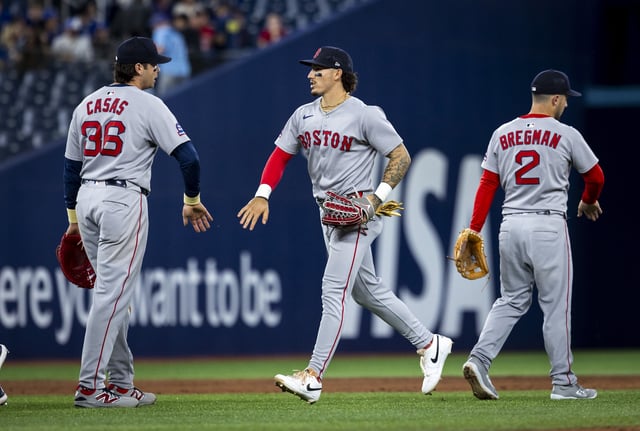 Alex Bregman #2, Jarren Duran #16 and Triston Casas #36 of the Boston Red Sox celebrate their 10-2 MLB game win over the Toronto Blue Jays at the Rogers Centre on April 29, 2025 in Toronto, Canada.