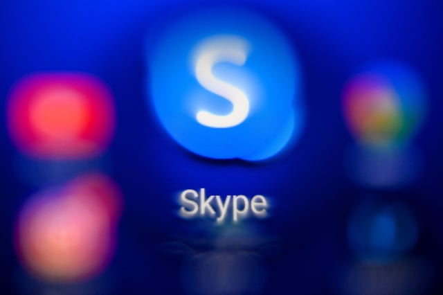 A photo illustration shows Skype's logo on a tablet.