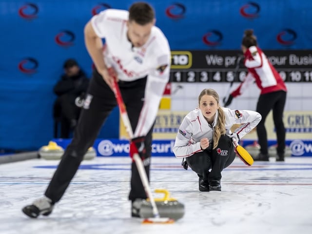 Canada's Jocelyn Peterman and Brett Gallant, left, in action during the Round Robin game between England and Canada at the World Mixed Doubles Curling Championship 2022, at the Sous-Moulin Sports Centre, in Geneva, Switzerland, Wednesday, April 27, 2022.