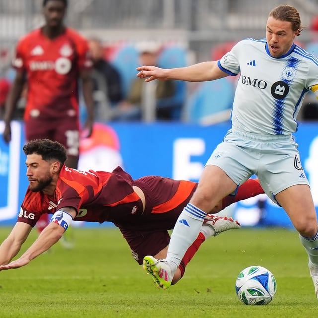 CF Montreal's Samuel Piette (right) knocks Toronto FC's Jonathan Osorio (21) off the ball during first half Canadian Championship preliminary round soccer action in Toronto on Wednesday, April 30, 2025. THE CANADIAN PRESS/Frank Gunn