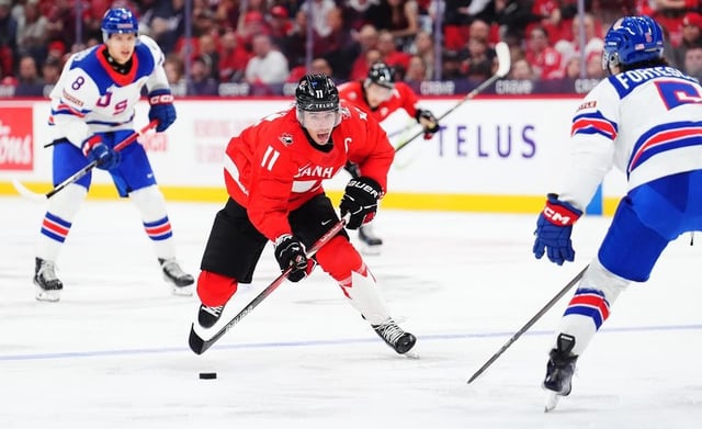 Canada's Brayden Yager (11) skates with the puck as USA's Drew Fortescue (5) defends during second period IIHF World Junior Hockey Championship tournament action in Ottawa on Tuesday, Dec. 31, 2024. THE CANADIAN PRESS/Sean Kilpatrick