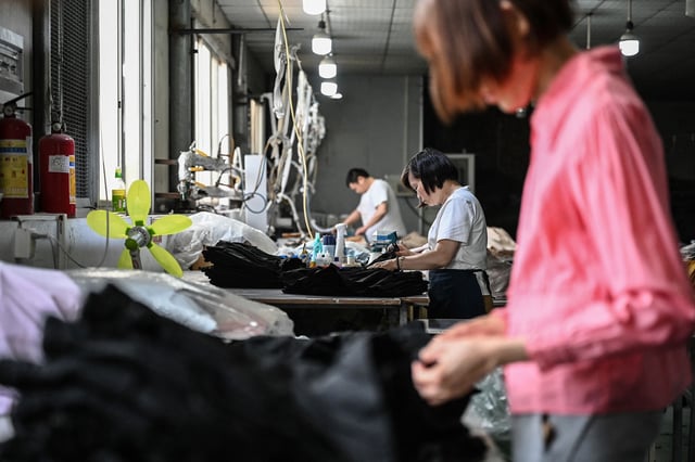 Employees produce garments for the online Chinese e-commerce company Temu at a clothing factory in Guangzhou, in southern China's Guangdong province on April 16, 2025. China told Washington on April 16 to "stop threatening and blackmailing" after US President Donald Trump said it was up to Beijing to come to the negotiating table to discuss ending their trade war. Trump has slapped new tariffs on friend and foe but has reserved his heaviest blows for China, with 145 percent on many Chinese imports even as Beijing has retaliated with levies on US goods of 125 percent.
