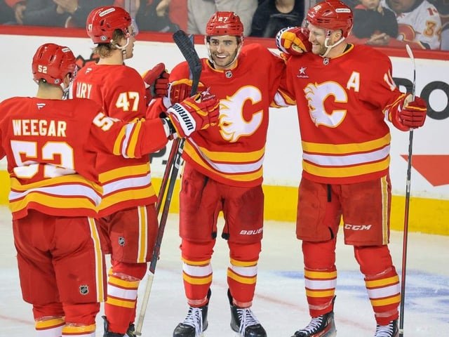 Calgary Flames forward Matt Coronato, centre, celebrates with teammates after scoring a goal against the Chicago Blackhawks at the Scotiabank Saddedome in Calgary on Dec. 21, 2024.Gavin Young/Postmedia