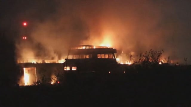 The retired BC Ferries vessel Queen of Sidney, that was in operation from 1960 to 2000, is seen on ablaze while it is moored on the Fraser River near Mission, B.C. on May 3,2025