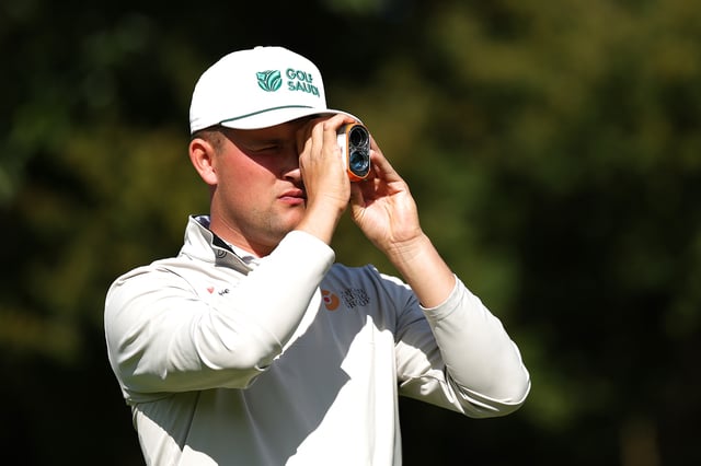 VIRGINIA WATER, ENGLAND - SEPTEMBER 17: Kipp Popert of England uses a range finder on the 18th hole during Round Two of the G4D Tour @ BMW PGA Championship prior to the BMW PGA Championship 2024 at Wentworth Club on September 17, 2024 in Virginia Water, England.