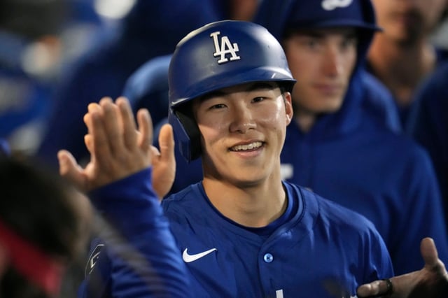 The Dodgers’ Hyeseong Kim, shown celebrating in the dugout after scoring during a Cactus League game against the Seattle Mariners in March 7, has been promoted from Triple-A, for what is likely a brief stint on the major-league roster. (AP Photo/Ross D. Franklin)
