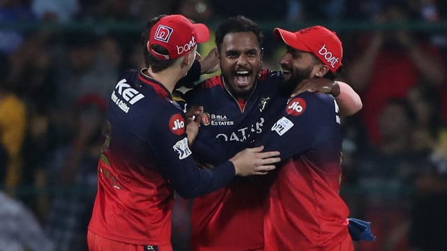 RCB's Yash Dayal celebrates with teammates after bowling the last ball to win the match against CSK.
