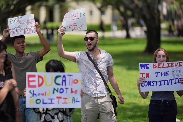 FILE - A group of Florida International University students protest against cuts in federal funding and an agreement by campus police to partner with Immigration and Customs Enforcement, on the FIU campus on a day of protests around the country in support of higher education, Thursday, April 17, 2025, in Miami. (AP Photo/Rebecca Blackwell, File)