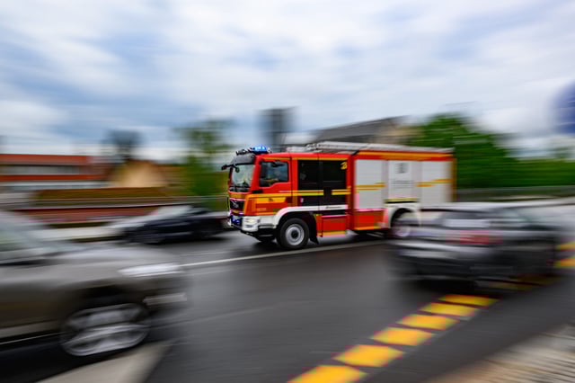 Ein Rüstwagen der Feuerwehr fährt mit Blaulicht zu einem Einsatz (Symbolbild)