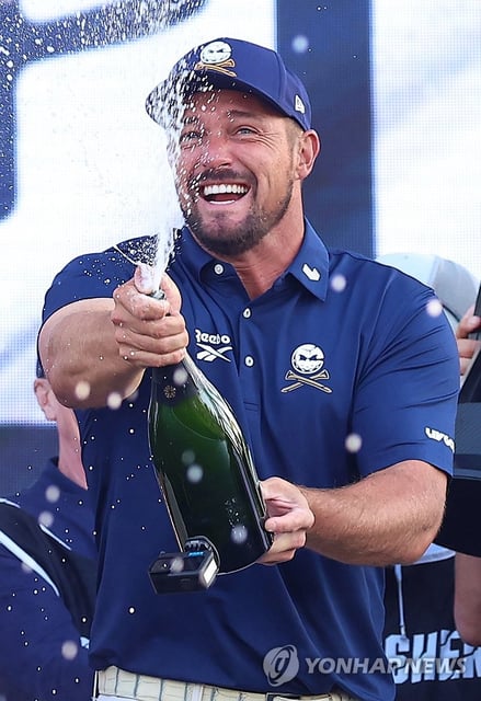 Bryson DeChambeau of the United States sprays champagne in celebration of his victory at Golf Korea at Jack Nicklaus Golf Club Korea in Incheon, west of Seoul, on May 4, 2025. (Yonhap)