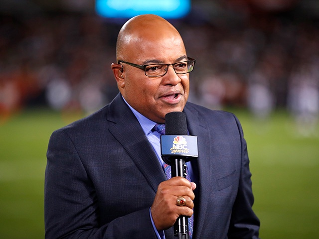 In this Sept. 5, 2019, file photo, NBC sportscaster Mike Tirico works the sidelines during an NFL football game between the Green Bay Packers and the Chicago Bears in Chicago. (AP Photo/Jeff Haynes, File)
