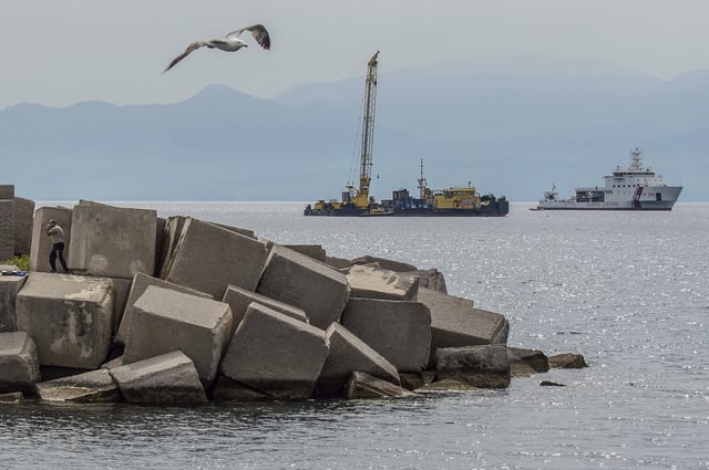 Italian Coast Guard's Luigi Dattilo CP940 patrol vessel, right, assists the multi-purpose floating work barge Hebo Lift 2 monitoring the stretch of sea off Porticello, near Palermo, Sicily, Italy, Sunday, May 4, 2025, where the British superyacht Bayesian sunk on August 19, 2024 as the operations for its recovery start. (AP Photo/Salvatore Cavalli)