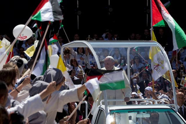 Pope Francis arrives to celebrate mass in Manger Square next to the Church of the Nativity, believed by many to be the birthplace of Jesus Christ, in the West Bank city of Bethlehem May 25, 2014. REUTERS/Andrew Medichini/Pool/File Photo