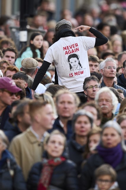 A person protests during a solemn annual national service to commemorate the war dead in Amsterdam, Netherlands, Sunday, May 4, 2025. (AP Photo/Peter Dejong)
