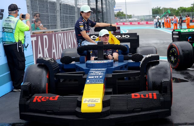 Formula One F1 - Miami Grand Prix - Miami International Autodrome, Miami, Florida, United States - May 4, 2025 Red Bull's Yuki Tsunoda and Max Verstappen in a full sized Lego replica F1 car during the drivers parade REUTERS/Brian Snyder
