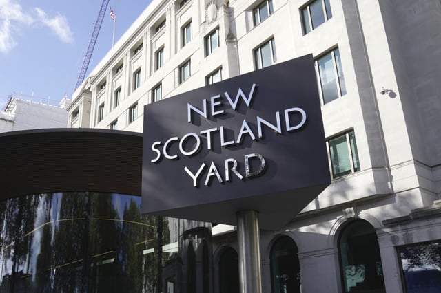 A sign stands in front of the New Scotland Yard, the headquarters of the London Metropolitan Police, in London on Sept. 25, 2023.